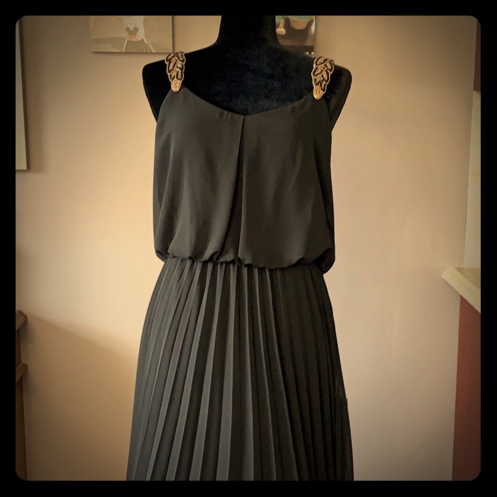 Long black dress with gold embellished straps.